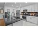 Modern kitchen with stainless appliances, granite countertops, and bright white cabinetry at 144 Sea Trail Dr, Mooresville, NC 28117