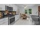Modern kitchen featuring stainless steel appliances, granite countertops, and a cozy breakfast nook at 144 Sea Trail Dr, Mooresville, NC 28117