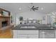 Bright open-concept kitchen with a granite island, stainless appliances, and a brick fireplace at 144 Sea Trail Dr, Mooresville, NC 28117