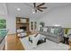 Bright living room with vaulted ceilings, brick fireplace, and French doors to the patio at 144 Sea Trail Dr, Mooresville, NC 28117