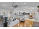 Open-concept living area with modern kitchen, bright white cabinets and eat-in breakfast area at 144 Sea Trail Dr, Mooresville, NC 28117