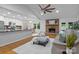 Inviting living room with open layout, brick fireplace, and seamless flow to the kitchen at 144 Sea Trail Dr, Mooresville, NC 28117