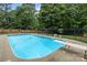 Backyard pool surrounded by a fence with diving board and lounge space at 144 Sea Trail Dr, Mooresville, NC 28117