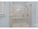 Modern shower with glass doors, a built-in bench, and adjustable shower head at 144 Sea Trail Dr, Mooresville, NC 28117