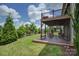 Outdoor deck featuring a covered area with comfortable seating and a landscaped yard at 14503 Crest Ct, Charlotte, NC 28278