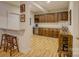 Basement bar area with wooden cabinets, marble countertops, wine cooler, and stylish bar stools at 14503 Crest Ct, Charlotte, NC 28278