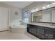 An elegant bathroom with a soaking tub, double vanity, and modern finishes at 14503 Crest Ct, Charlotte, NC 28278