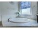 Close up of soaking tub with decorative tile work and hardware at 14503 Crest Ct, Charlotte, NC 28278
