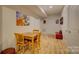 Cozy game area with a wooden table and chairs, red bench, and decorative artwork at 14503 Crest Ct, Charlotte, NC 28278