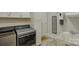 Bright laundry room with modern washer and dryer, plus utility sink and mirror at 14503 Crest Ct, Charlotte, NC 28278
