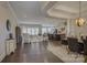 Open-concept living room with dark wood floors and modern light fixtures at 14503 Crest Ct, Charlotte, NC 28278