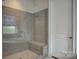 A modern shower with glass enclosure and neutral toned tile at 14503 Crest Ct, Charlotte, NC 28278