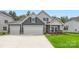 Charming two-story home with a three car garage, beautiful lawn, and manicured landscaping at 1528 Croydon St, Indian Land, SC 29707