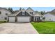 Charming home featuring a three-car garage, well-manicured lawn and inviting curb appeal at 1528 Croydon St, Indian Land, SC 29707