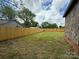 Fenced backyard of the stone house, showing a well-maintained lawn at 157 5Th N Ave, Taylorsville, NC 28681