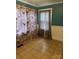 Stylized bedroom with tan tile floor, decorative teal walls, white wainscoting and eye-catching patterned curtains at 157 5Th N Ave, Taylorsville, NC 28681
