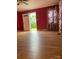 Living room with hardwood floors, an inviting doorway to the backyard, and beautiful floral curtains at 157 5Th N Ave, Taylorsville, NC 28681