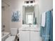 Well-lit bathroom featuring a modern vanity, a large mirror, and a shower-tub combination at 1707 Cannon View Ln, Charlotte, NC 28208