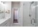 Bright bathroom featuring a modern vanity, marble countertop, and glass shower at 1707 Cannon View Ln, Charlotte, NC 28208