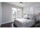 Sunlit bedroom with large windows, ceiling fan, and comfortable bed with stylish decor at 1707 Cannon View Ln, Charlotte, NC 28208