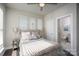 Cozy bedroom with natural light, a ceiling fan, and an ensuite bathroom with modern finishes at 1707 Cannon View Ln, Charlotte, NC 28208