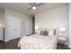 Bedroom with ceiling fan, dresser, and comfortable bed with decorative pillows at 1707 Cannon View Ln, Charlotte, NC 28208