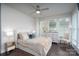 Light and airy bedroom featuring a ceiling fan, dresser, and an inviting bed at 1707 Cannon View Ln, Charlotte, NC 28208