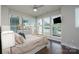 Bright bedroom with large windows, ceiling fan, dresser, and a comfortable bed at 1707 Cannon View Ln, Charlotte, NC 28208