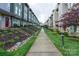View of a row of townhouses with well-manicured lawns and inviting sidewalks at 1707 Cannon View Ln, Charlotte, NC 28208