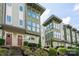 Inviting townhouse exterior with multi-level facade, front yard landscaping, and steps to a welcoming red door at 1707 Cannon View Ln, Charlotte, NC 28208