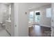Hallway featuring a view of bedroom with ceiling fan and bathroom with marble countertop at 1707 Cannon View Ln, Charlotte, NC 28208