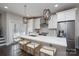 Bright, open kitchen with white cabinets, marble countertops, stainless steel appliances, and breakfast bar seating at 1707 Cannon View Ln, Charlotte, NC 28208