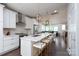 Bright, open kitchen with white cabinets, marble countertops, and stainless steel appliances overlooking the living area at 1707 Cannon View Ln, Charlotte, NC 28208