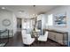 Open-concept living and dining area with hardwood floors, modern lighting, and ample natural light at 1707 Cannon View Ln, Charlotte, NC 28208