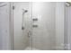 Modern glass shower with chrome fixtures and built-in shelving at 1707 Cannon View Ln, Charlotte, NC 28208