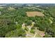 An aerial view showcases this property nestled amongst lush green trees and expansive land at 1818 Winfield Dr, Monroe, NC 28110