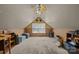 Cozy attic space with neutral walls, a ceiling fan, carpet flooring, and natural light at 1818 Winfield Dr, Monroe, NC 28110