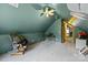 Attic featuring a rocking chair, slanted teal walls, carpet flooring and a doorway at 1818 Winfield Dr, Monroe, NC 28110