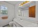 Bright bathroom featuring a single sink, vanity with drawers, and a window with natural light at 1818 Winfield Dr, Monroe, NC 28110