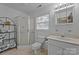 Bathroom featuring a glass shower, toilet, vanity, mirror, and natural light at 1818 Winfield Dr, Monroe, NC 28110