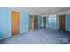 Bedroom featuring blue walls, blue carpet, and closet doors leading to multiple rooms at 1818 Winfield Dr, Monroe, NC 28110