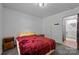 Cozy bedroom with neutral walls, carpet, and view into the bathroom at 1818 Winfield Dr, Monroe, NC 28110