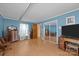 Spacious bedroom with wood-look flooring, blue walls, multiple dressers, and mirrored closet doors at 1818 Winfield Dr, Monroe, NC 28110