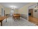 Dining room features tile flooring, a chandelier, and a wooden table with chairs at 1818 Winfield Dr, Monroe, NC 28110