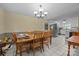Traditional dining room with wood table, seating for six, chandelier, and white tile floors near kitchen at 1818 Winfield Dr, Monroe, NC 28110
