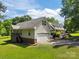 View of the home showcasing the garage, ramp access, and well-maintained landscaping at 1818 Winfield Dr, Monroe, NC 28110