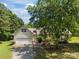 Aerial of home with attached garage, ramp, and mature trees providing ample shade at 1818 Winfield Dr, Monroe, NC 28110