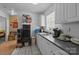 The galley kitchen features white cabinets, tiled floor and stainless steel sink at 1818 Winfield Dr, Monroe, NC 28110
