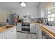 Bright kitchen featuring white cabinets, stainless steel appliances, and tile flooring at 1818 Winfield Dr, Monroe, NC 28110