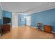 Bright living room with blue walls, wood-look flooring, a TV, and a comfortable seating arrangement at 1818 Winfield Dr, Monroe, NC 28110